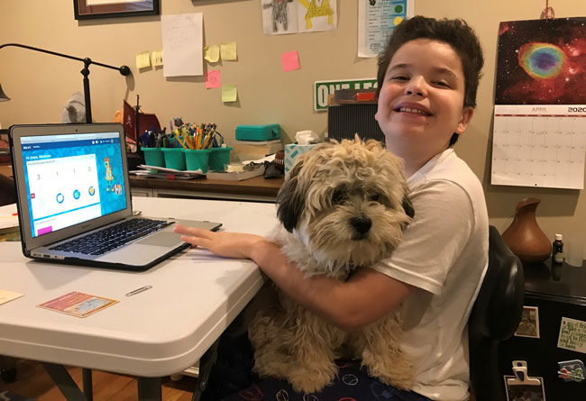 Diener Distance Learning student and his puppy at the computer